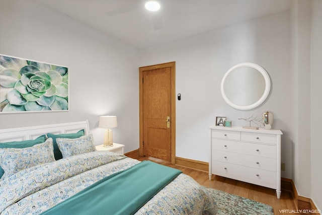bedroom with baseboards, a ceiling fan, and wood finished floors