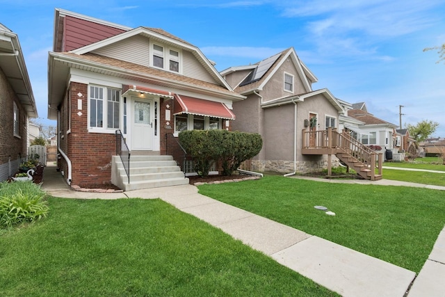 bungalow-style home featuring brick siding and a front yard