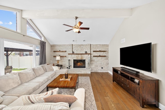 living room with ceiling fan, beam ceiling, a fireplace, high vaulted ceiling, and wood finished floors