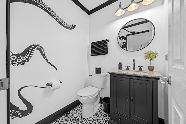 bathroom featuring crown molding, vanity, tile patterned floors, baseboards, and toilet