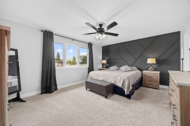 bedroom featuring a ceiling fan, baseboards, and light carpet