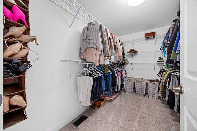 spacious closet featuring carpet flooring and visible vents