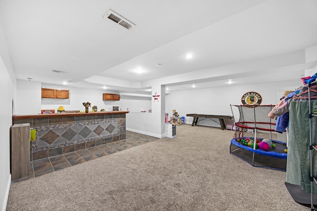 interior space with visible vents, carpet flooring, recessed lighting, and a dry bar