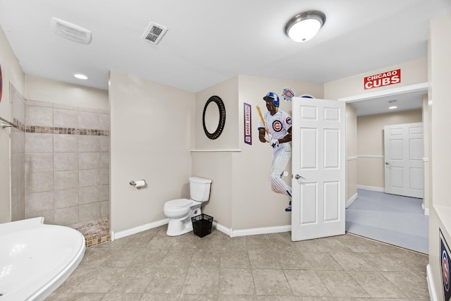 bathroom featuring a walk in shower, a sink, toilet, baseboards, and visible vents