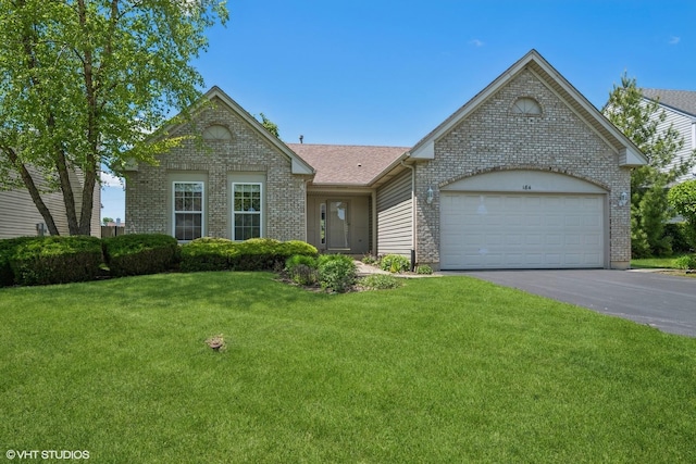 184 Stillwater Dr, Hainesville, IL 60030 - single story home featuring brick siding, a front lawn, asphalt driveway, and an attached garage
