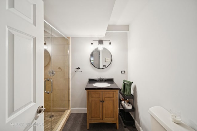 6122 S Greenwood Ave Unit 1S, Chicago, IL 60637 - bathroom featuring baseboards, a stall shower, toilet, and vanity