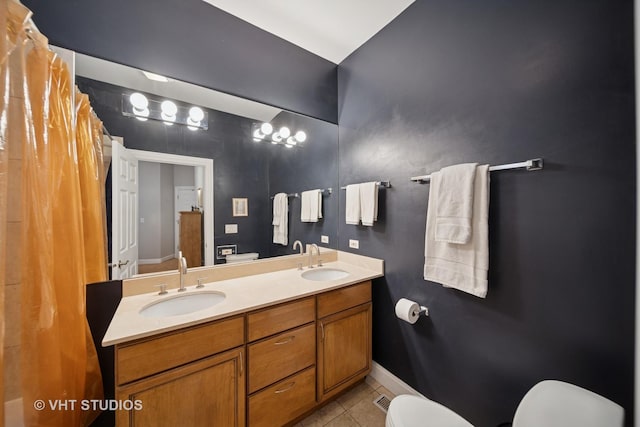 6122 S Greenwood Ave Unit 1S, Chicago, IL 60637 - bathroom featuring toilet, tile patterned flooring, baseboards, and double vanity