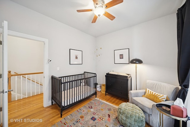 6122 S Greenwood Ave Unit 1S, Chicago, IL 60637 - bedroom featuring wood finished floors, a nursery area, and ceiling fan