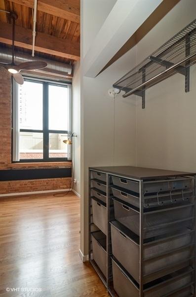 interior space featuring beamed ceiling, wood finished floors, and baseboards