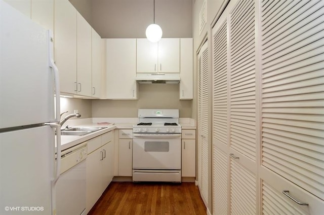 kitchen featuring a sink, white appliances, light countertops, under cabinet range hood, and dark wood-type flooring
