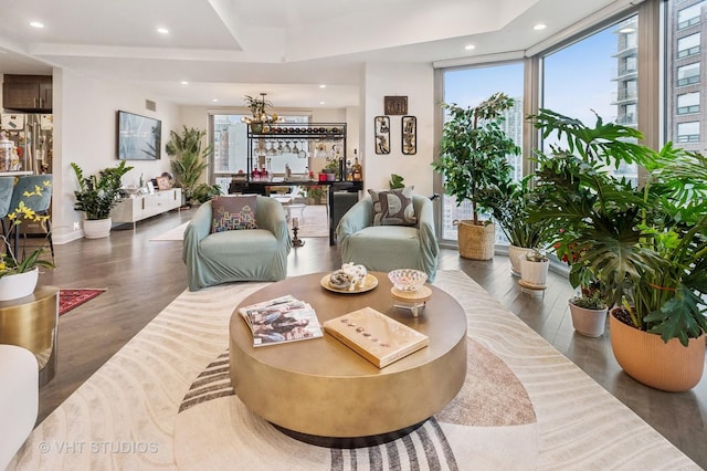living area with an inviting chandelier, wood finished floors, and recessed lighting