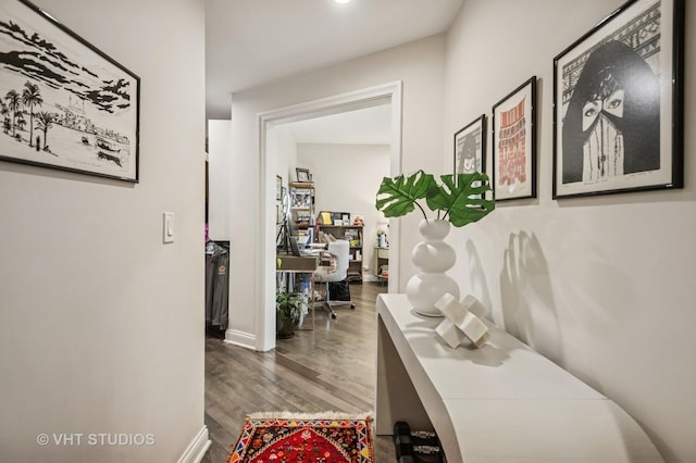 hallway with wood finished floors and baseboards