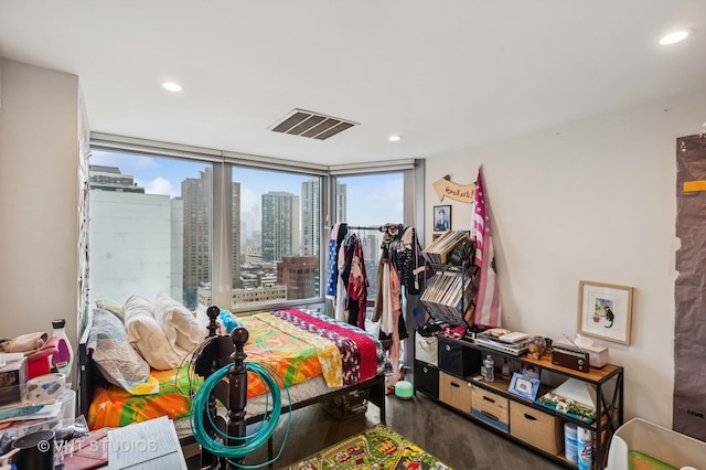 bedroom featuring a view of city, recessed lighting, visible vents, and wood finished floors