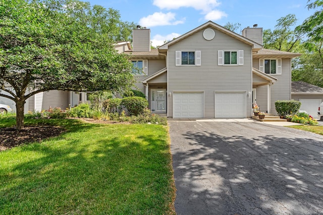 4232 Caribou Ct, Joliet, IL 60431 - view of front of property with a chimney, asphalt driveway, an attached garage, and a front yard