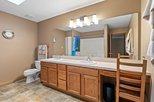 4232 Caribou Ct, Joliet, IL 60431 - bathroom featuring double vanity, a shower with shower curtain, a textured ceiling, and stone finish flooring