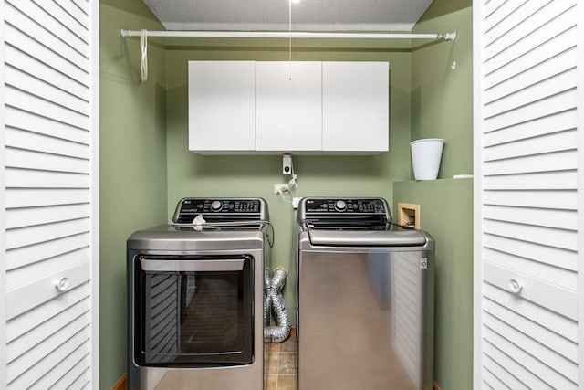 4232 Caribou Ct, Joliet, IL 60431 - laundry room with cabinet space, washing machine and dryer, and a textured ceiling