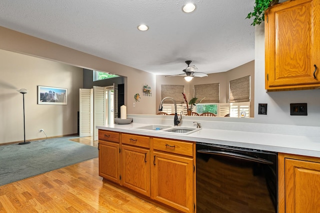 4232 Caribou Ct, Joliet, IL 60431 - kitchen featuring black dishwasher, light countertops, brown cabinets, light wood-style floors, and ceiling fan