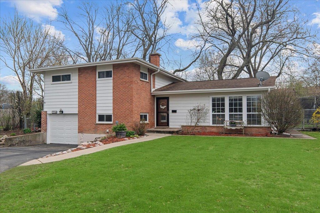 1657 Cranshire Ct, Deerfield, IL 60015 - tri-level home with a chimney, aphalt driveway, an attached garage, a front yard, and brick siding