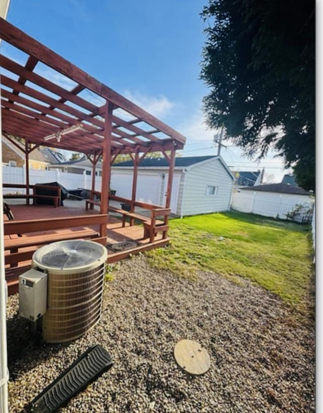 view of yard featuring a deck, a pergola, central air condition unit, and a fenced backyard