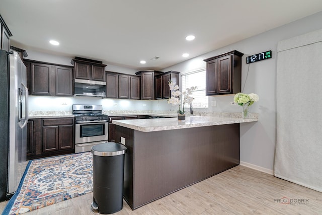 267 Maryland Ln, Pingree Grove, IL 60140 - kitchen with light wood finished floors, stainless steel appliances, a peninsula, dark brown cabinets, and light countertops