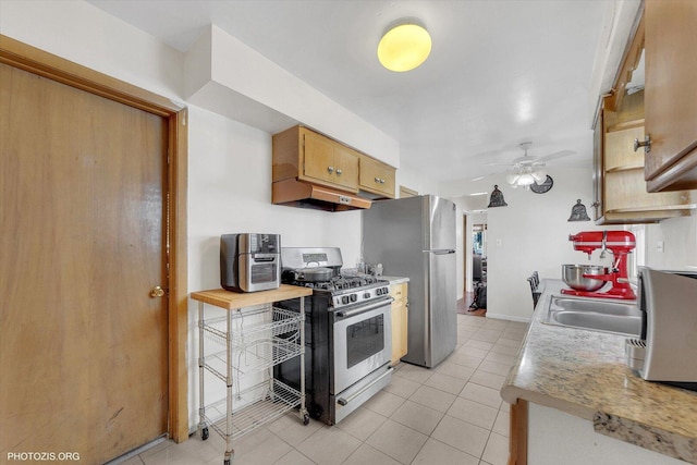 kitchen featuring a sink, ceiling fan, light countertops, under cabinet range hood, and appliances with stainless steel finishes