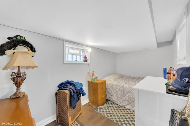 bedroom with light wood-type flooring and baseboards