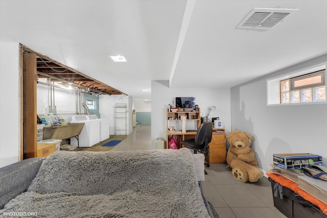 interior space with washer and dryer, tile patterned flooring, and visible vents