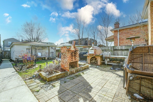 view of patio / terrace with an outdoor kitchen and fence