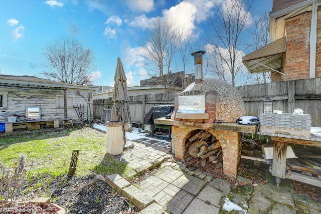 view of patio featuring grilling area and fence