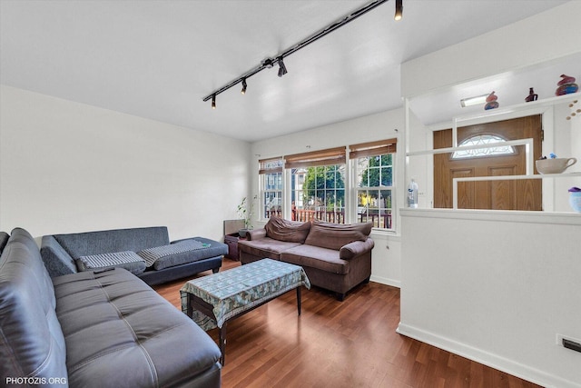 living area featuring wood finished floors, track lighting, and baseboards
