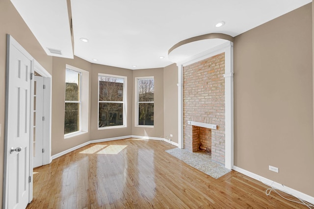 6547 S Woodlawn Ave Unit 2, Chicago, IL 60637 - unfurnished living room with light wood-style flooring, baseboards, a brick fireplace, visible vents, and recessed lighting