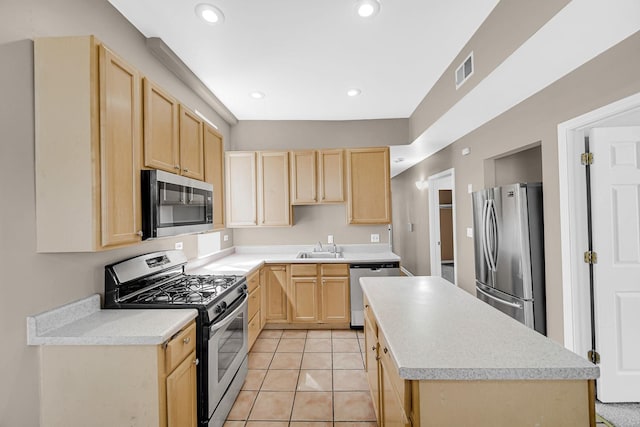 6547 S Woodlawn Ave Unit 2, Chicago, IL 60637 - kitchen with a center island, appliances with stainless steel finishes, visible vents, and light brown cabinetry