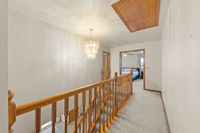 2398 S Williamsburg Dr, Plainfield, IL 60586 - hallway featuring attic access, an upstairs landing, and light colored carpet