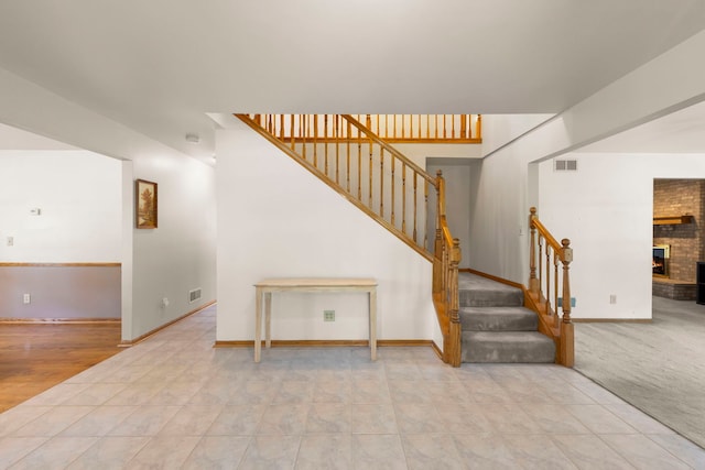 2398 S Williamsburg Dr, Plainfield, IL 60586 - staircase with a fireplace and baseboards