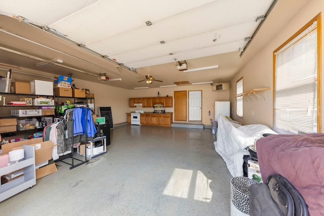 2398 S Williamsburg Dr, Plainfield, IL 60586 - garage featuring a garage door opener, a wall mounted AC, and ceiling fan