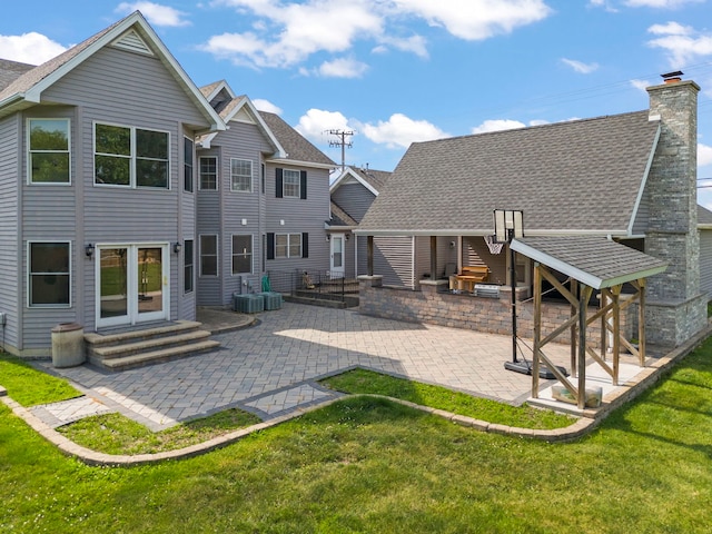 2398 S Williamsburg Dr, Plainfield, IL 60586 - rear view of property featuring entry steps, a patio, a lawn, and a shingled roof