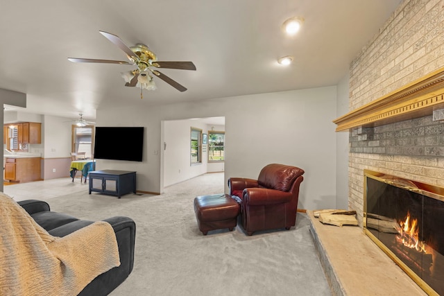 2398 S Williamsburg Dr, Plainfield, IL 60586 - living room featuring ceiling fan, a brick fireplace, and light colored carpet