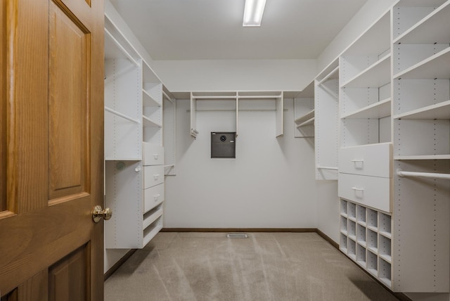 walk in closet with carpet