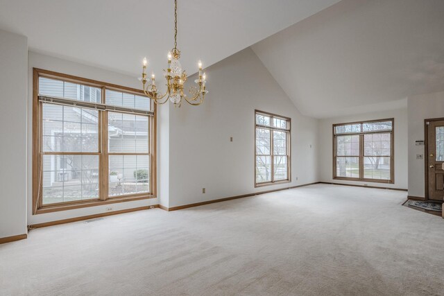 interior space with an inviting chandelier, baseboards, light colored carpet, and plenty of natural light