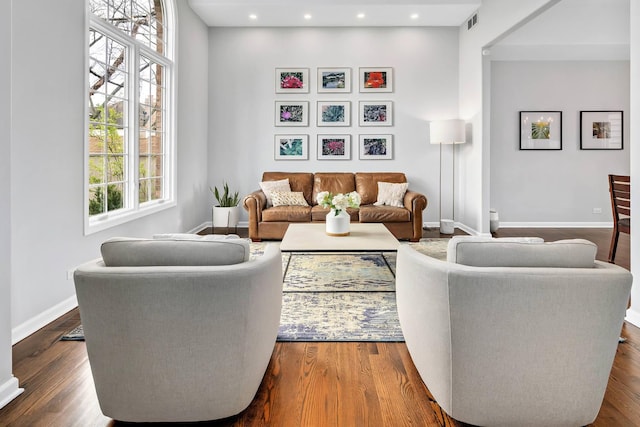 living area featuring baseboards, dark wood-style floors, and recessed lighting