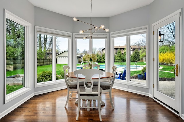 sunroom featuring a chandelier and a healthy amount of sunlight