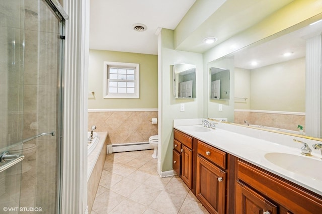 full bath featuring tile patterned flooring, a sink, baseboard heating, and toilet