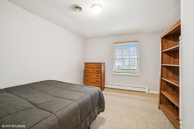 carpeted bedroom featuring baseboards, a baseboard heating unit, and visible vents
