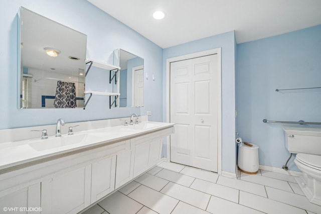 bathroom with a sink, tile patterned floors, toilet, and curtained shower