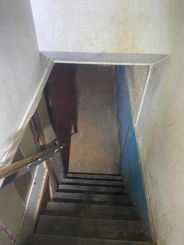 stairway with concrete flooring