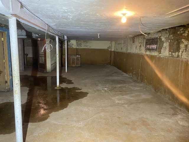 unfinished below grade area featuring heating unit