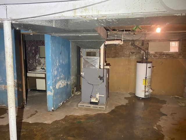 basement with water heater, heating unit, and visible vents
