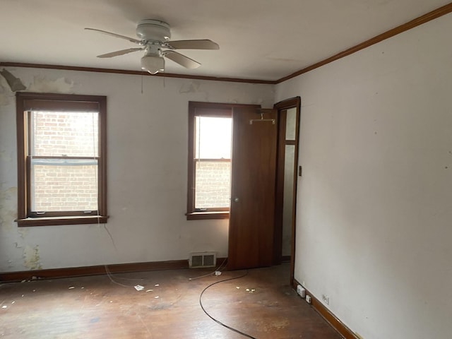unfurnished room with baseboards, ceiling fan, ornamental molding, and visible vents