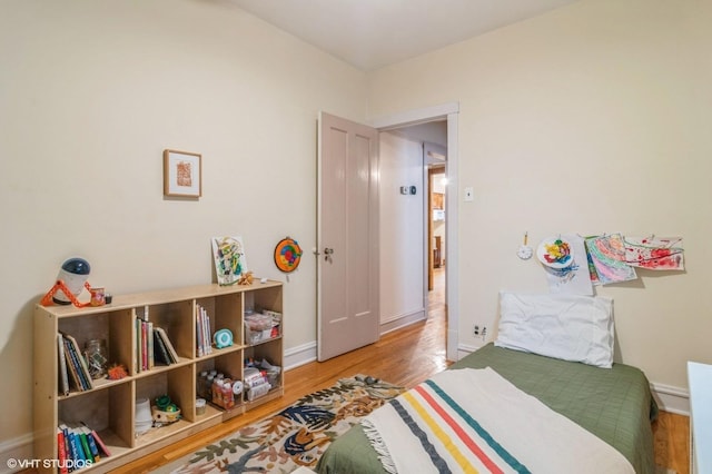 bedroom featuring light wood-style floors and baseboards