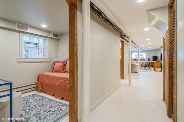 hall with visible vents, recessed lighting, and a baseboard heating unit